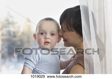 Stock Photo - A happy mother and baby. Fotosearch