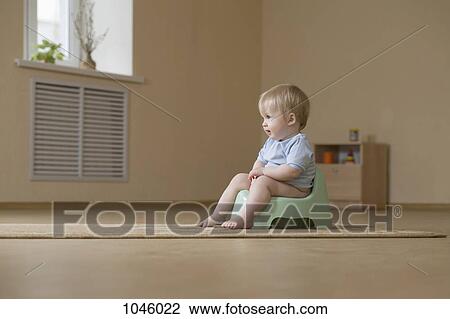 A happy toddler sitting on a potty chair, looking away View Large Photo Image Stock Image - A happy toddler sitting on a potty chair, looking away. Fotosearch