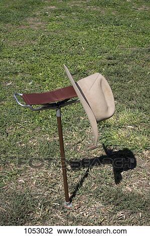 A hat on a folding chair View Large Photo Image Stock Image - A hat on a folding chair. Fotosearch