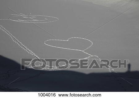 A heart shape and smiley face stamped out in the snow by footprints View Large Photo Image Stock Photograph - A heart shape and smiley face stamped out in the snow by footprints. Fotosearch