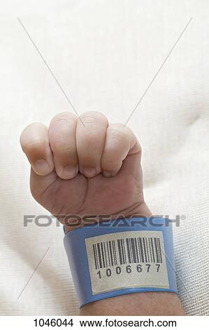 A hospital ID bracelet on a baby's wrist View Large Photo Image Picture - A hospital ID bracelet on a baby's wrist. Fotosearch