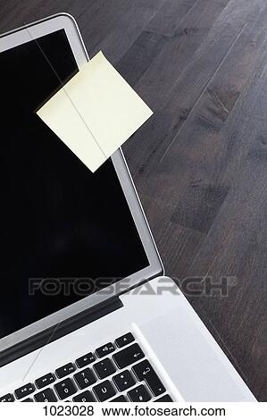 A laptop with a blank adhesive note attached to it View Large Photo Image Stock Photo - A laptop with a blank adhesive note attached to it. Fotosearch