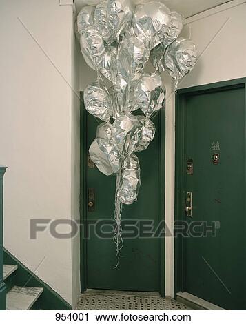 A large bunch of helium balloons in an apartment corridor View Large Photo Image Stock Image - A large bunch of helium balloons in an apartment corridor. Fotosearch