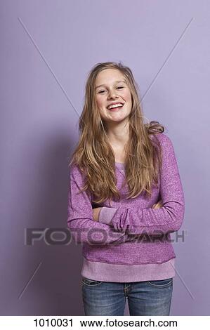 A laughing teenage girl with arms crossed, portrait, studio shot View Large Photo Image Stock Image - A laughing teenage girl with arms crossed, portrait, studio shot. Fotosearch