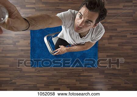 A man changing a light bulb, overhead view View Large Photo Image Stock Photo - A man changing a light bulb, overhead view. Fotosearch
