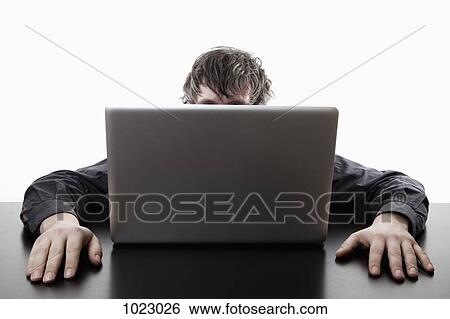 A man hiding behind a laptop View Large Photo Image Stock Photograph - A man hiding behind a laptop. Fotosearch