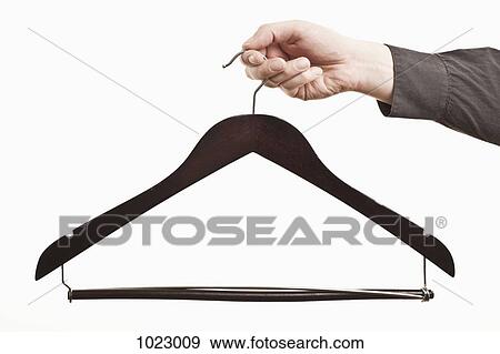 A man holding out an empty hanger, close-up of hand View Large Photo Image Stock Photo - A man holding out an empty hanger, close-up of hand. Fotosearch