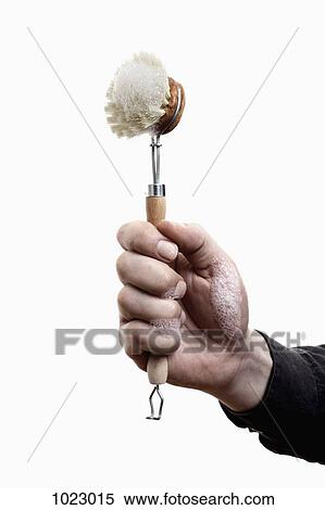 A man holding up a scrub brush with soap suds on it, close-up of hand View Large Photo Image Stock Photography - A man holding up a scrub brush with soap suds on it, close-up of hand. Fotosearch