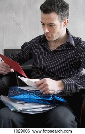 A man looking through his mail View Large Photo Image Stock Photograph - A man looking through his mail. Fotosearch