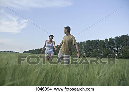 A man pulling his girlfriend through a field View Large Photo Image Picture - A man pulling his girlfriend through a field. Fotosearch