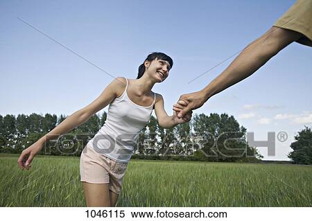 A man pulling his girlfriend through a field View Large Photo Image Stock Photography - A man pulling his girlfriend through a field. Fotosearch