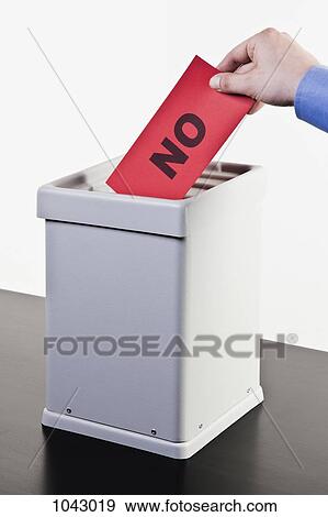 A man putting a ballot with the word NO written on it into a ballot box, close-up hands View Large Photo Image Stock Photo - A man putting a ballot with the word NO written on it into a ballot box, close-up hands. Fotosearch
