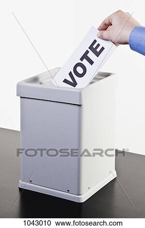 A man putting a ballot with the word VOTE written on it into a ballot box, close-up hands View Large Photo Image Stock Image - A man putting a ballot with the word VOTE written on it into a ballot box, close-up hands. Fotosearch