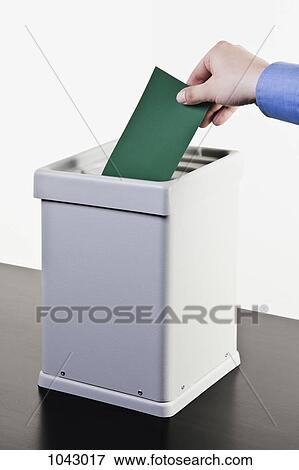 A man putting a blank green ballot into a ballot box, close-up hands View Large Photo Image Stock Photo - A man putting a blank green ballot into a ballot box, close-up hands. Fotosearch