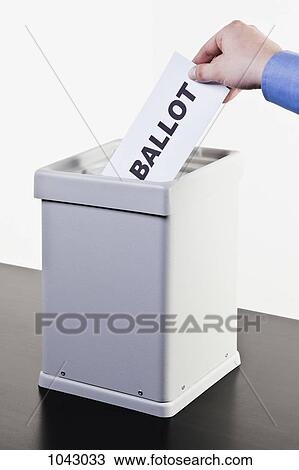 A man putting a paper with the word BALLOT written on it into a ballot box, close-up hands View Large Photo Image Stock Image - A man putting a paper with the word BALLOT written on it into a ballot box, close-up hands. Fotosearch