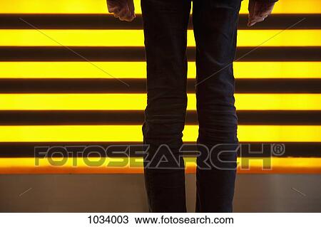 A man standing in front of lights, rear view, low section View Large Photo Image Stock Image - A man standing in front of lights, rear view, low section. Fotosearch