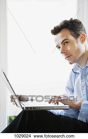 A man thinking while using a laptop View Large Photo Image Picture - A man thinking while using a laptop. Fotosearch