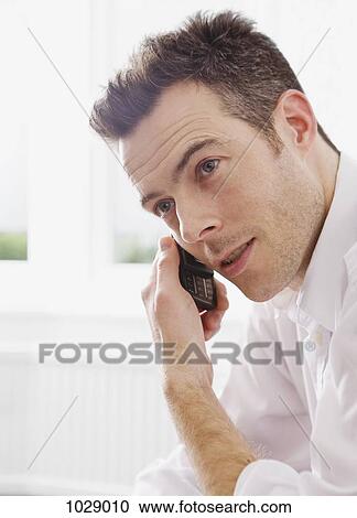 A man using a mobile phone View Large Photo Image Stock Image - A man using a mobile phone. Fotosearch