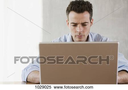 A man working at home View Large Photo Image Stock Photography - A man working at home. Fotosearch