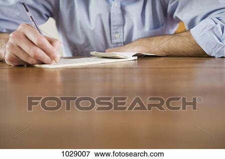 A man writing a check, focus on hands View Large Photo Image Stock Photo - A man writing a check, focus on hands. Fotosearch
