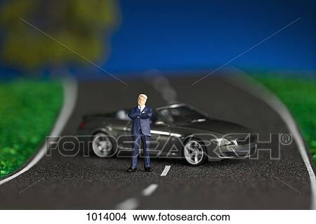 A miniature businessman figurine and miniature sports car View Large Photo Image Picture - A miniature businessman figurine and miniature sports car. Fotosearch