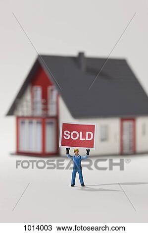 A miniature construction worker figurine holding aloft a SOLD sign View Large Photo Image Stock Image - A miniature construction worker figurine holding aloft a SOLD sign. Fotosearch
