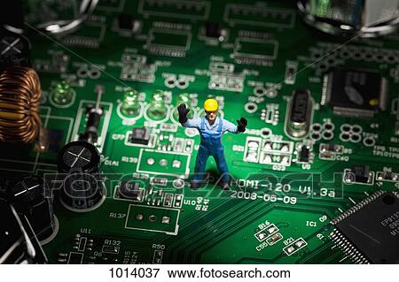 A miniature figurine construction worker standing on a computer mother board View Large Photo Image Stock Photo - A miniature figurine construction worker standing on a computer mother board. Fotosearch