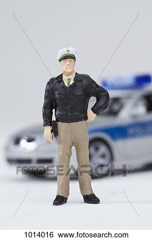 A miniature policeman figurine standing by a miniature police car View Large Photo Image Stock Photograph - A miniature policeman figurine standing by a miniature police car. Fotosearch