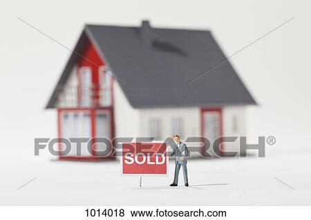 A miniature real estate agent figurine standing next to a SOLD sign View Large Photo Image Stock Photo - A miniature real estate agent figurine standing next to a SOLD sign. Fotosearch
