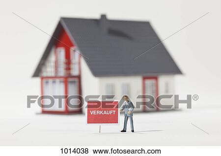 A miniature real estate agent figurine standing next to a VERKAUFT (sold in German) sign View Large Photo Image Stock Photo - A miniature real estate agent figurine standing next to a VERKAUFT (sold in German) sign. Fotosearch