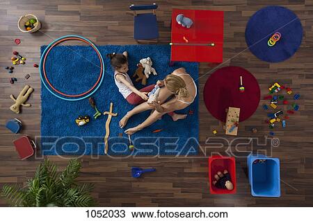 A mother and daughter playing with toys in a living room, overhead view View Large Photo Image Stock Image - A mother and daughter playing with toys in a living room, overhead view. Fotosearch