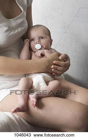 A mother holding her newborn baby View Large Photo Image Stock Image - A mother holding her newborn baby. Fotosearch