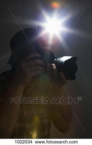 A photographer using a camera and flash View Large Photo Image Picture - A photographer using a camera and flash. Fotosearch