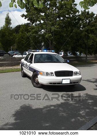 A police car with its emergency lights on parked on a street View Large Photo Image Stock Image - A police car with its emergency lights on parked on a street. Fotosearch