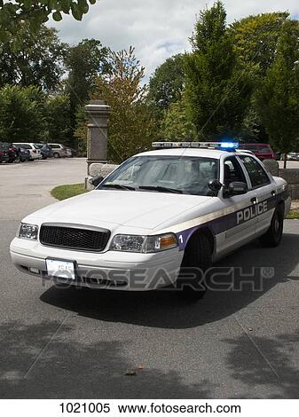 A police car with its emergency lights on parked on a street View Large Photo Image Stock Photography - A police car with its emergency lights on parked on a street. Fotosearch
