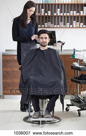 Stock Photo - A satisfied customer in a hair salon. Fotosearch