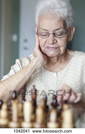 A senior woman playing chess View Large Photo Image Stock Image - A senior woman playing chess. Fotosearch