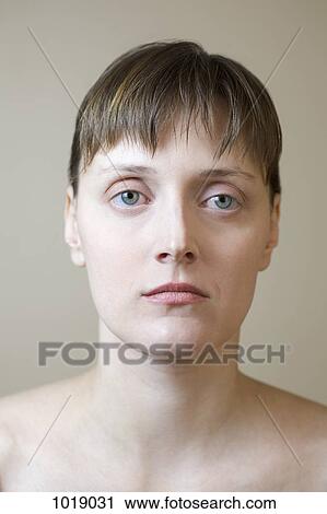 Stock Image - A serious woman staring off camera. Fotosearch