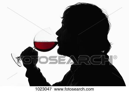 A silhouetted man drinking red wine from a wineglass View Large Photo Image Stock Photo - A silhouetted man drinking red wine from a wineglass. Fotosearch