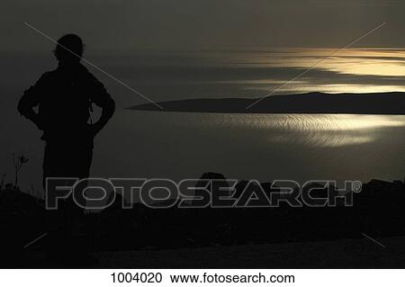 A silhouetted woman looking at a view of the Adriatic Sea near Unije, Croatia View Large Photo Image Stock Image - A silhouetted woman looking at a view of the Adriatic Sea near Unije, Croatia. Fotosearch