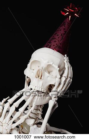 A skeleton wearing a party hat and looking surprised View Large Photo Image Stock Photo - A skeleton wearing a party hat and looking surprised. Fotosearch