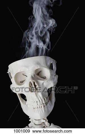 A skeleton with smoke coming out of its skull View Large Photo Image Stock Photo - A skeleton with smoke coming out of its skull. Fotosearch