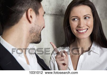 A smiling businesswoman scolding a businessman View Large Photo Image Stock Image - A smiling businesswoman scolding a businessman. Fotosearch