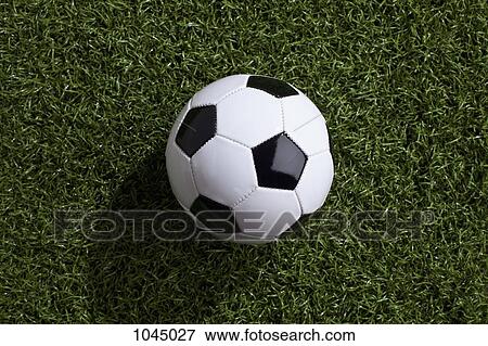 Stock Photo - A soccer ball on turf. Fotosearch