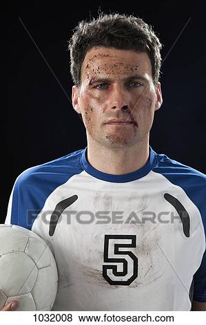 A soccer player with a bloody nose holding a soccer ball View Large Photo Image Stock Photo - A soccer player with a bloody nose holding a soccer ball. Fotosearch