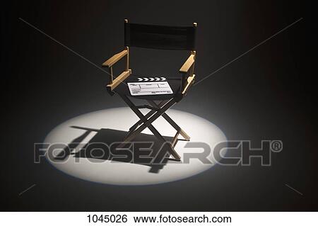 A spot lit directors chair and a clapper board View Large Photo Image Stock Photograph - A spot lit directors chair and a clapper board. Fotosearch