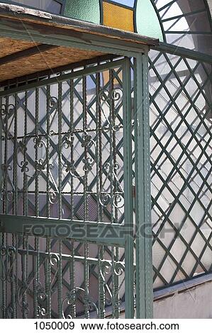 A stained glass window and wrought iron door View Large Photo Image Stock Photo - A stained glass window and wrought iron door. Fotosearch