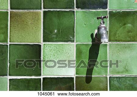 A tap on a green tiled wall View Large Photo Image Stock Image - A tap on a green tiled wall. Fotosearch