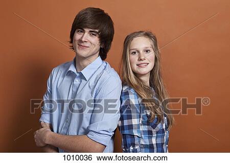 A teenage boy and girl, portrait, studio shot View Large Photo Image Stock Photograph - A teenage boy and girl, portrait, studio shot. Fotosearch