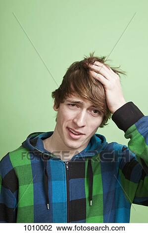 A teenage boy looking embarrassed, portrait, studio shot View Large Photo Image Stock Image - A teenage boy looking embarrassed, portrait, studio shot. Fotosearch